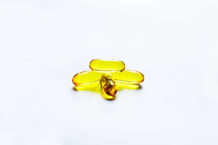 Fish oil capsules on white background and texture., Fish oil capsules and container., selective...