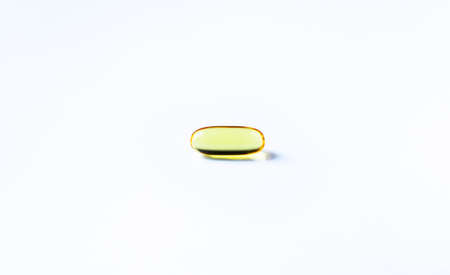 Fish oil capsules on white background and texture., Fish oil capsules and container., selective focus.の写真素材