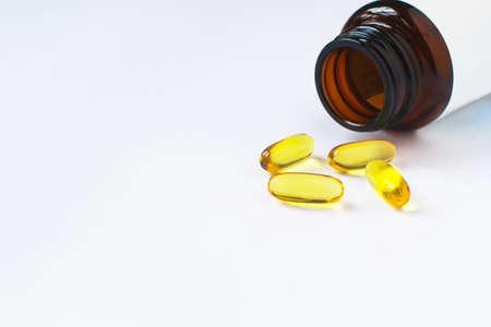 Fish oil capsules on white background and texture., Fish oil capsules and container., selective focus.の写真素材