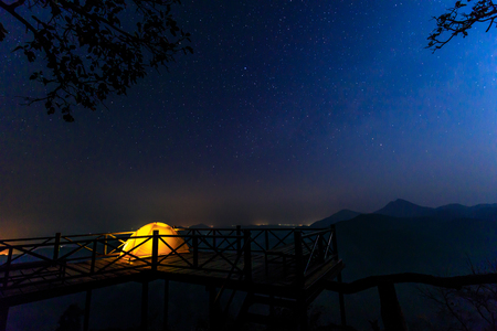 Lonely camping on the mountain under the stars and blue sky.の写真素材