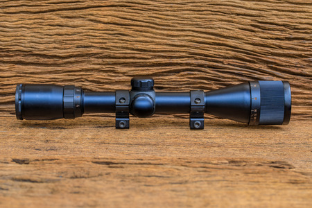 The riflescopes  on old wooden  background .