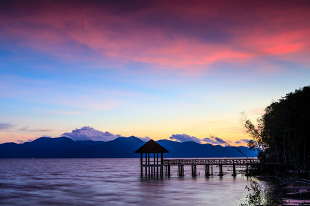 Colorful sunset on the sea in black beach, Trat province, Thailand.の写真素材