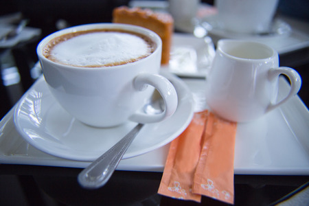 white coffee set with cakeの写真素材