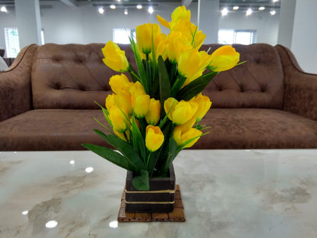 Bouquet of yellow tulips in a vase on the tableの写真素材