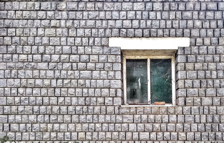 Old stone wall with broken window. Background and texture for design.