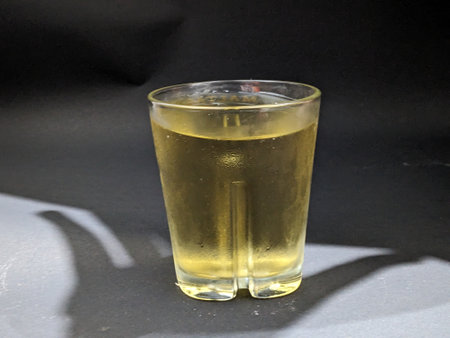 A glass of beer on a black background. Alcoholic drink.