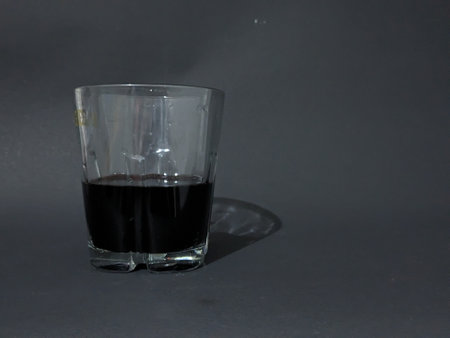 Black coffee in a glass isolated on black background. Close up.の写真素材