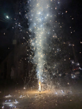 Fireworks in the night sky with a lot of smoke and sparksの写真素材