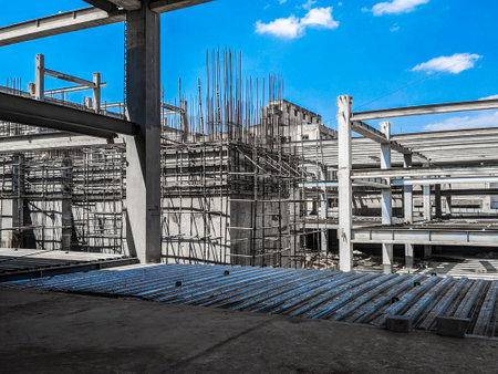 Steel structure with scaffolding and blue sky in a construction site.