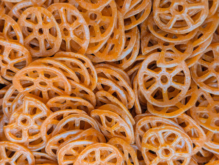 Close up of a pile of dried orange pretzels, background