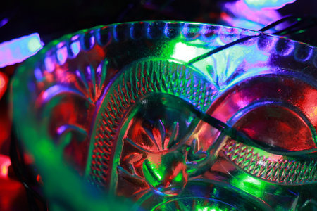 Close up of a colorful glass vase with bright lights in the backgroundの写真素材