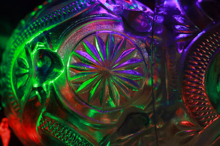 Close up of a colorful glass skull with green and red lights.の写真素材