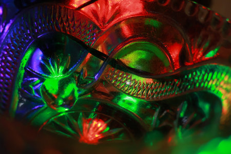 Close-up of a crystal mask. Colorful abstract background.