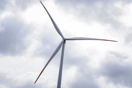 An image of windturbine generator on a cloudy sky background