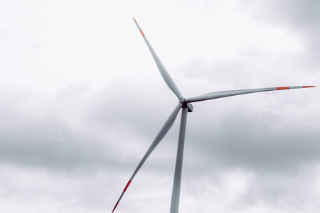 An image of windturbine generator on a cloudy sky backgroundの写真素材