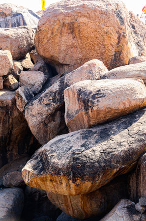 Close-up view of massive stone boulders at Anjanadri showcases layered rocks and earthy tones under daylight.の写真素材