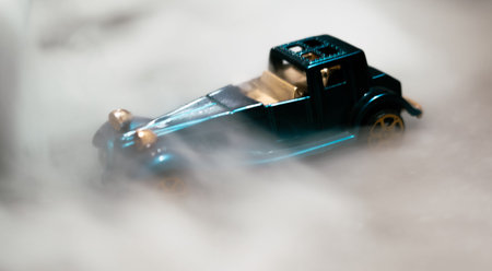 Toy car with smoke on a black background. Selective focus.の写真素材