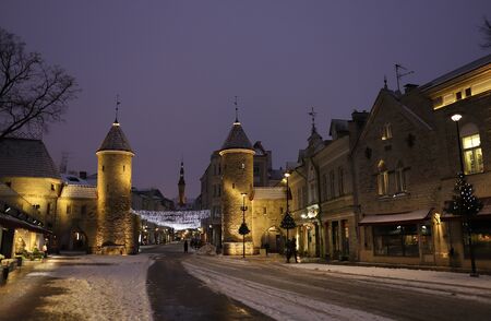 Tallinn, Estonia - January 7 2019 : view of old town gates with castle towers and a Town Hall in winter at blue hour. Europe tourist attraction.のeditorial素材