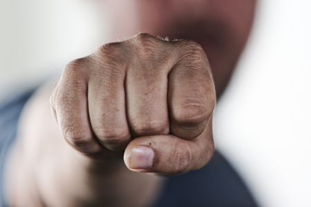 Aggressive man punching with fistの写真素材