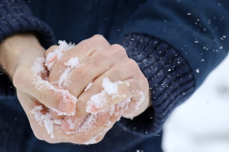 Man making snowballsの写真素材