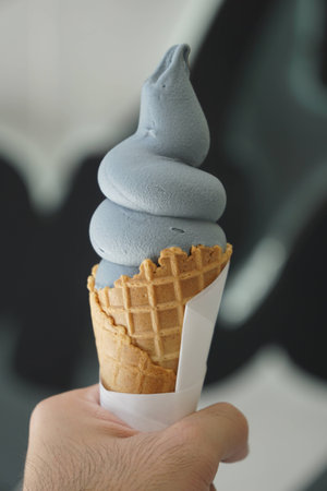 Hand holding Ice creamの写真素材