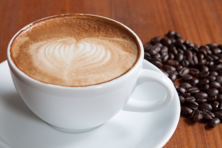 Coffee cup and beans on a wood tableの写真素材