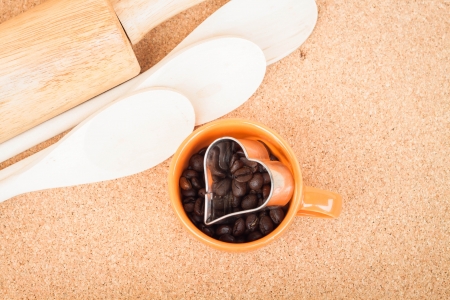 Cup of coffee bean and cookies cutter in kitchenの写真素材