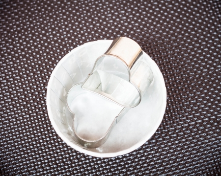 Forms for cookies in paper cup on grunde backgroundの写真素材