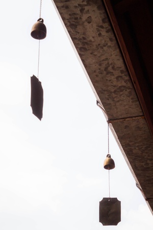 Small wind bell hang on eaves with white backgroundの写真素材
