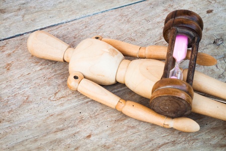Wood mannequin and hourglass display time relaxingの写真素材