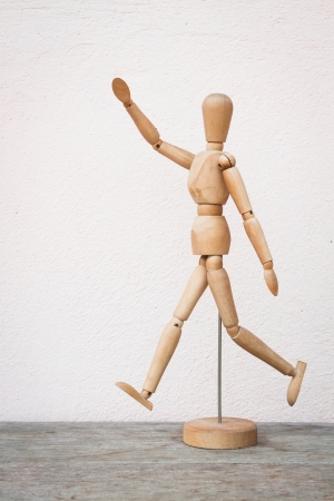 Wooden figure pose as happy jumping forwardの写真素材