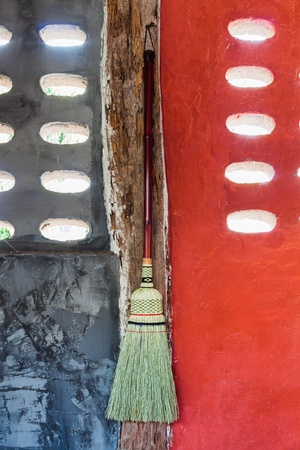 Broom hanging on the wall ready for cleaning workの写真素材