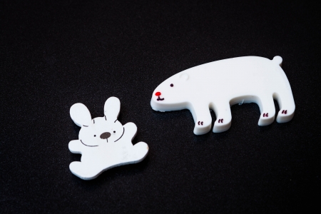 Close up white animal magnets on dark backgroundの写真素材