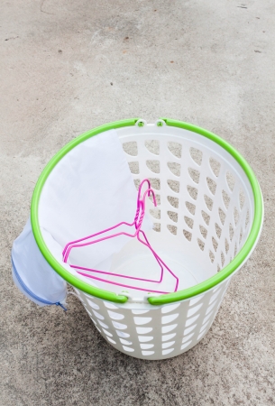 Cloth hanger and wash bag in plastic laundry basketの写真素材