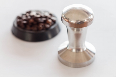 Coffee tamper and middle roasted coffee beanの写真素材