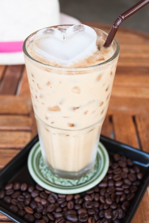 Cold glass coffee with milk and heart ice cubeの写真素材