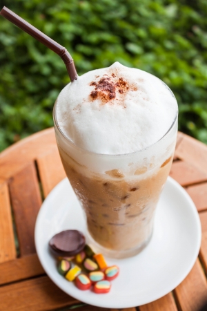 Refreshing iced milk coffee and some sweetの写真素材
