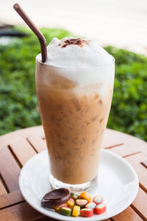 Refreshing glass of cold espresso and some sweetの写真素材