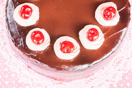 Top view of chocolate cake with red cherryの写真素材