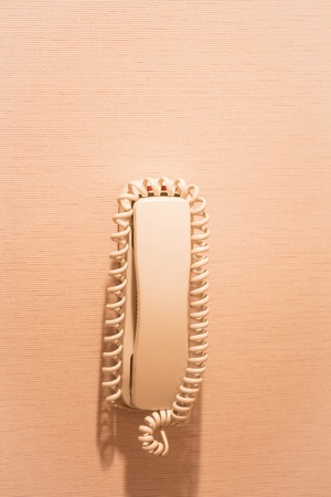 Restroom hanging telephone on cotton wallpaper backgroundの写真素材