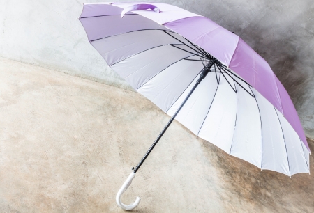 Purple silver bronze uv protection umbrella on the floorの写真素材