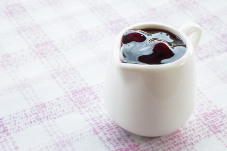 Ceramic pitcher of blueberry sauce, stock photoの写真素材