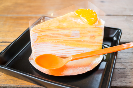 Delicious fresh orange crepe cake with sauce, stock photoの写真素材