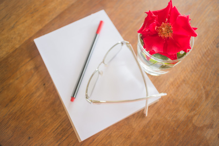 Beautiful red rose on work table, stock photoの写真素材