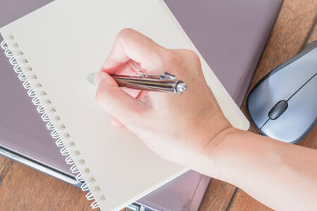 Hand writing on note paper at workplace, stock photoの写真素材