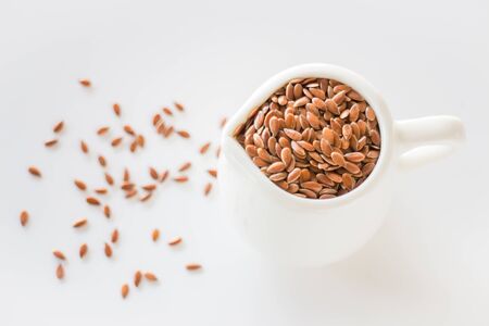 Pitcher of organic brown flaxseed, stock photoの写真素材