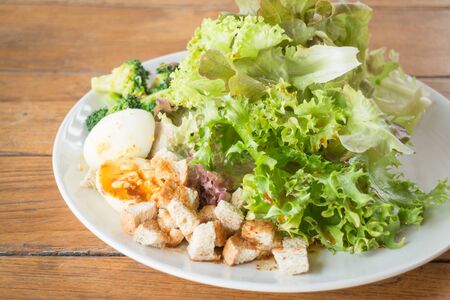 Homemade salad serving on wooden background, stock photoの写真素材