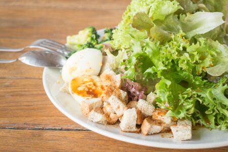Homemade salad serving on wooden table, stock photoの写真素材