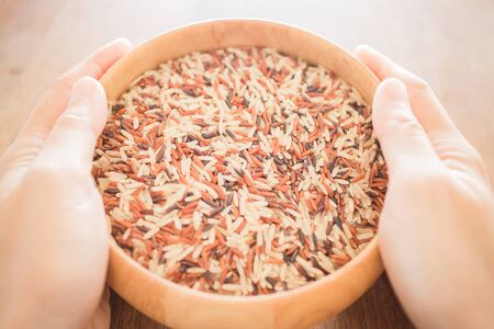 Hand hold multi whole jusmine rice bowl, stock photoの写真素材