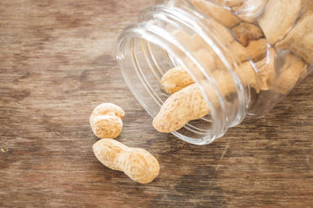 Salted peanuts on weathered wood, stock photoの写真素材